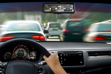 view from behind a steering wheel in traffic