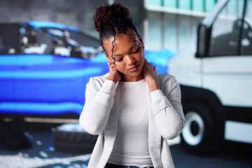 Woman holding neck after accident