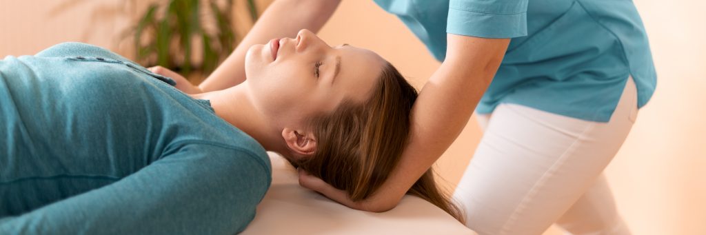 Chiropractor performing a gentle neck adjustment to relieve pain and improve mobility