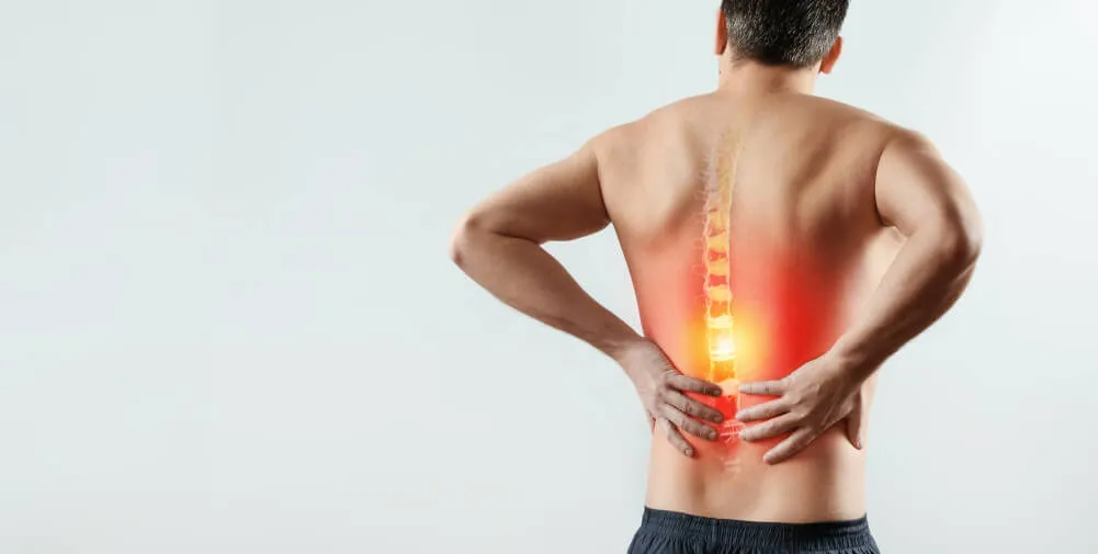 Man holding lower back in pain