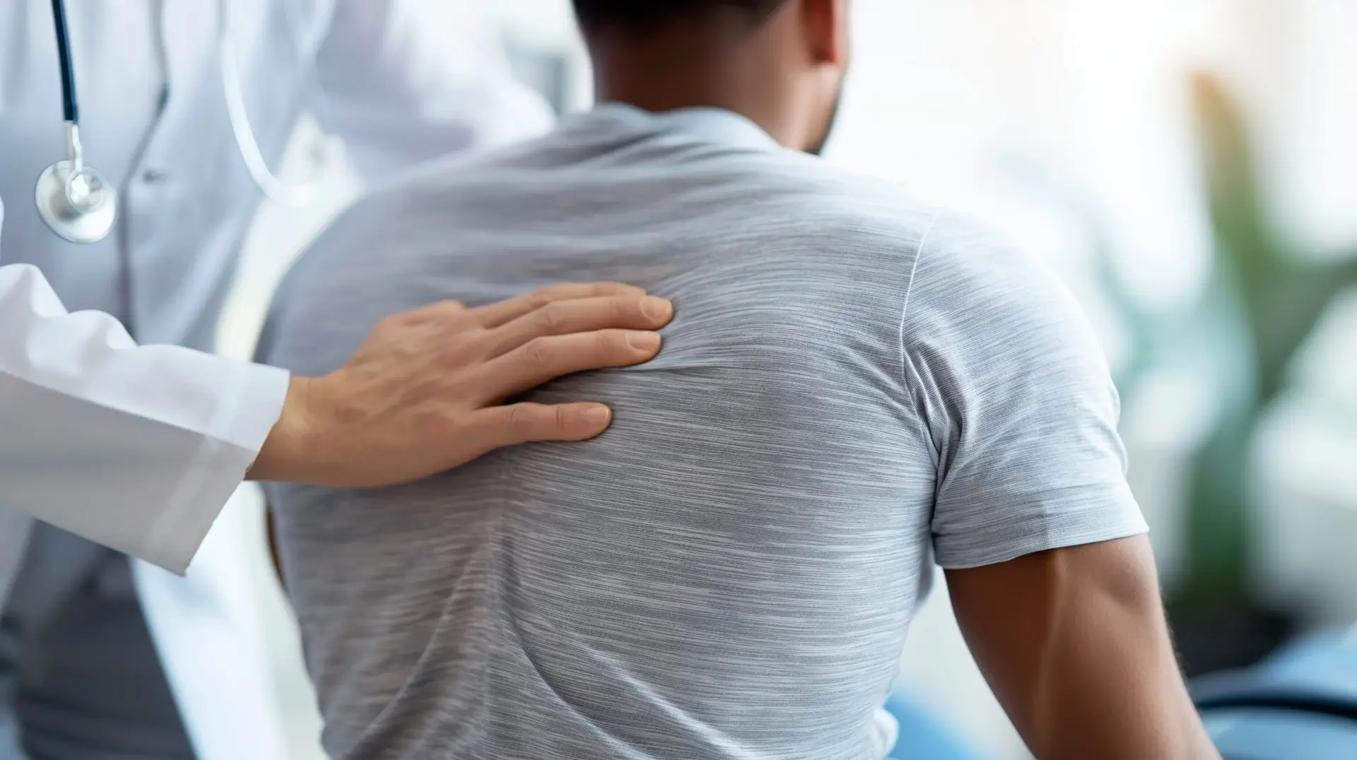 Doctor evaluating a patient experiencing shoulder pain